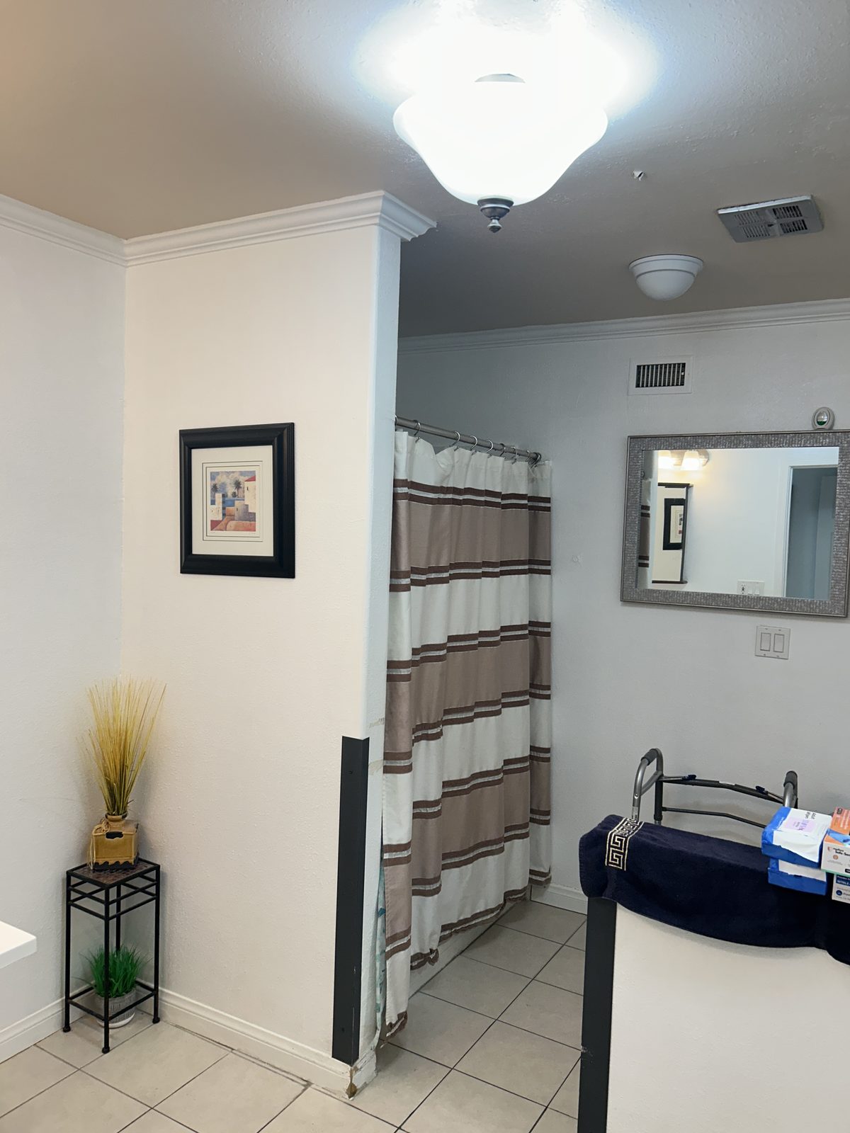 Comfortable resident bedroom with a bed, dresser, and seating